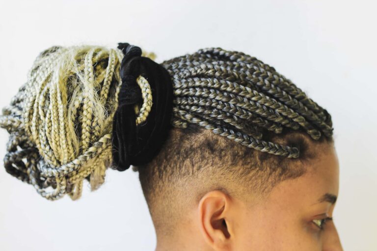Young afro with blonde Box braids, African hair style also known as "Kanekalon braids." Close up on decoration and style